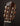 Close-up of a guitar headstock with tuning pegs on a dark background