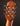 Close-up of a guitar headstock with tuning pegs on a dark background