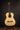 Classical acoustic guitar on a stand against a dark background