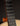 Close-up of a guitar neck with fretboard and strings on a dark background