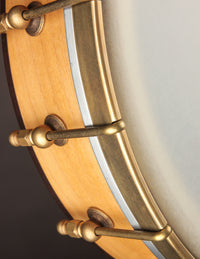 Close up of maple rim and brass hardware on a Rickard banjo