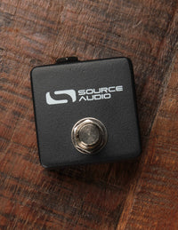 A black tap tempo switch with the brand name 'Source Audio' written on the front.