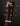 Close-up of a guitar headstock with brand logo on a dark background