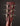 Close-up of a guitar headstock with tuning pegs on a dark background