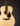 Acoustic guitar with a natural finish on a black background