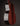 Close-up of a guitar's wooden body with a dark brown finish on a black background