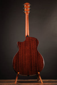 Taylor acoustic guitar on a dark background