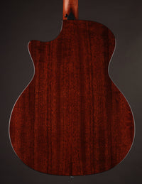 Back view of a Taylor acoustic guitar on a dark background