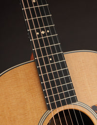 Close up of the neck on a Taylor guitar.