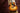 A Taylor Guitars Gold Label series acoustic guitar artfully displayed on a wooden bench. 