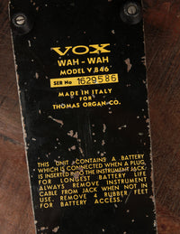 Vox wah-wah pedal with model number and text on a wooden surface