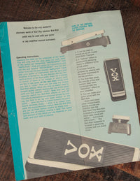 Vintage Vox pedal manual on a wooden surface