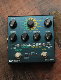 Source Audio One Series Collider Delay & Reverb pedal with various control knobs and footswitches on a wooden surface.