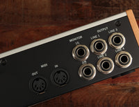 View of UA Volt476's four 1/4" outputs, monitor outputs, and MIDI in/out ports. 